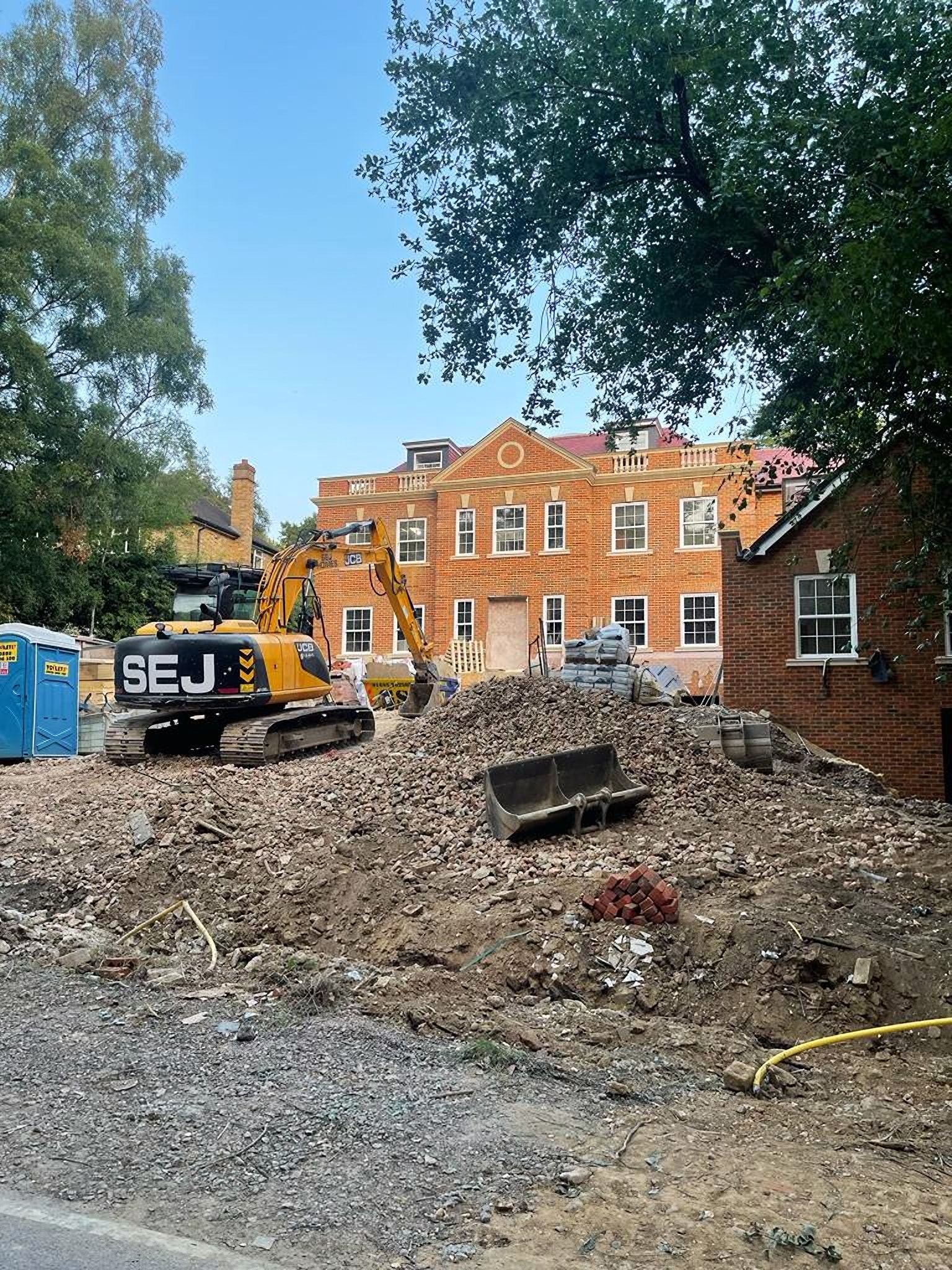 Groundworks under way at Camp Road, with an excavator on site