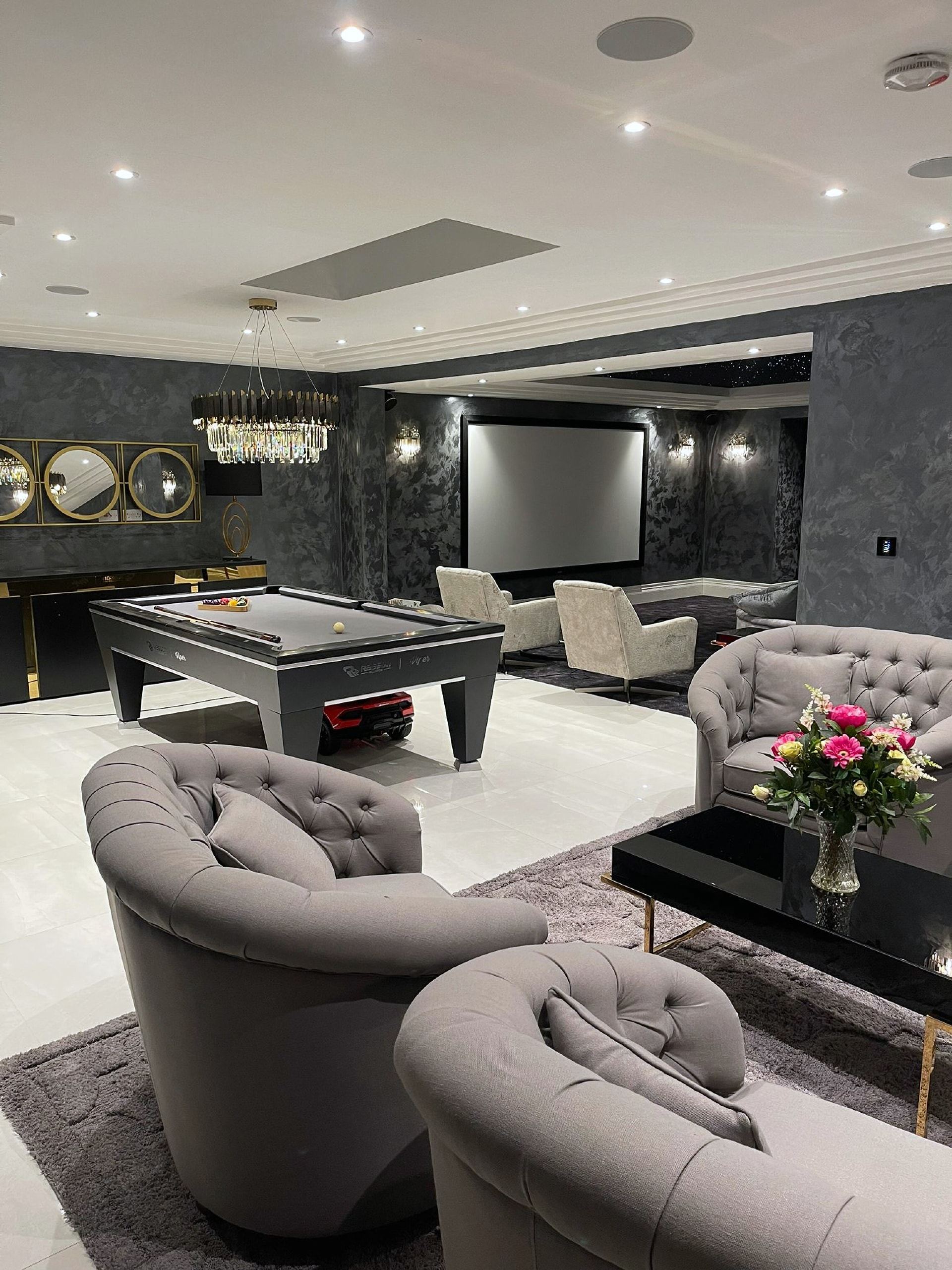 Lounge with velvet armchairs around a pool table