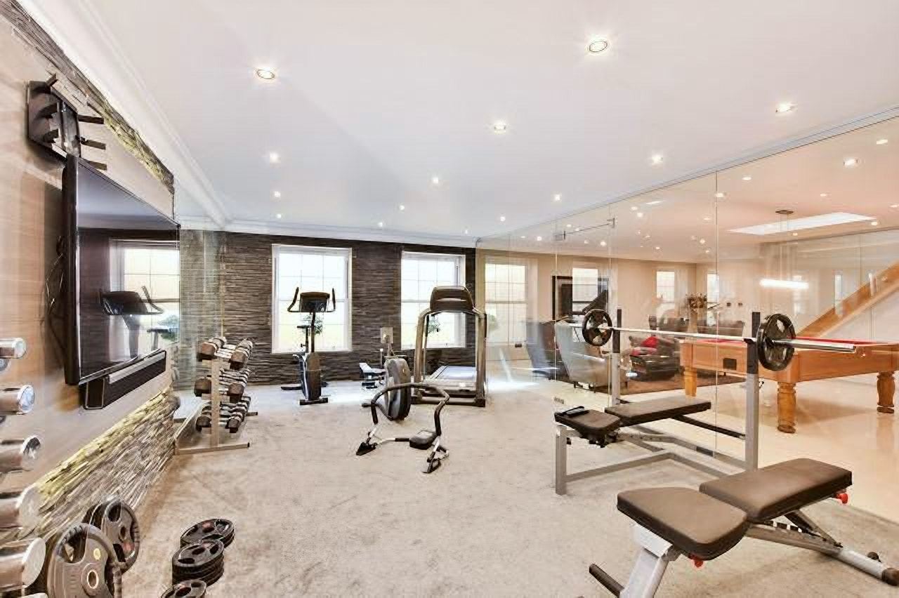 Basement gym with cardio and weights equipment