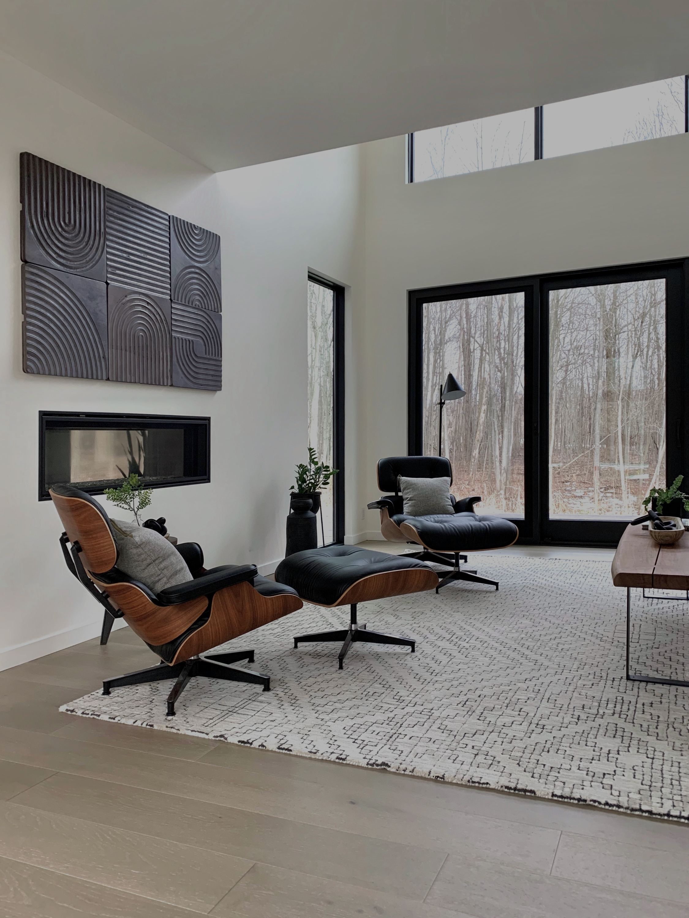 Modern living room with a leather lounge chair and tall windows