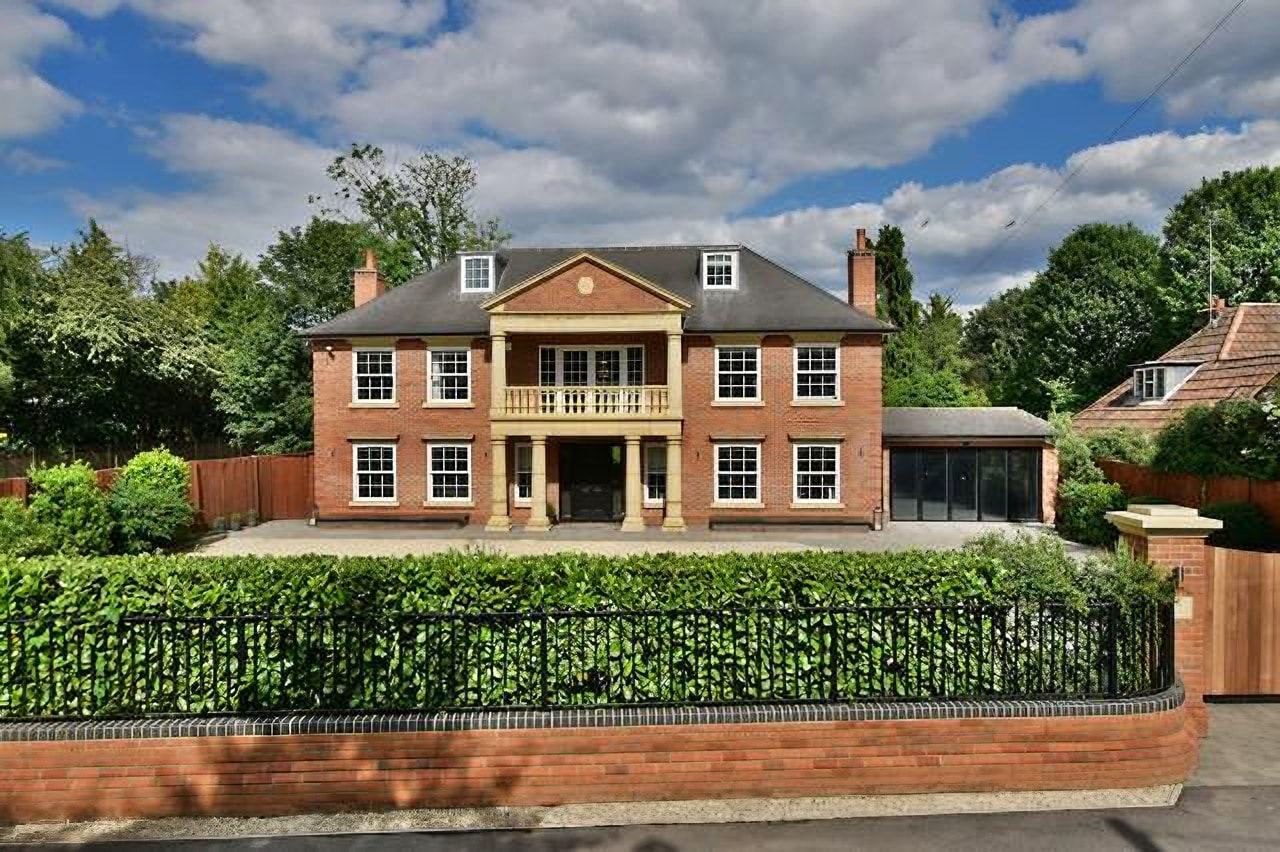 Large detached house in Iver with a first-floor balcony and a columned entrance