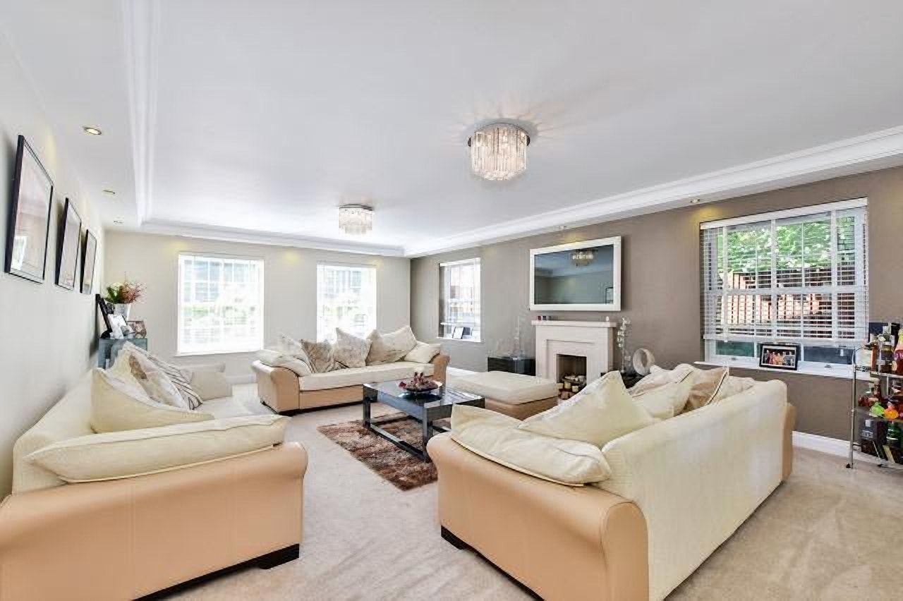 Bright living room with cream sofas and a fireplace
