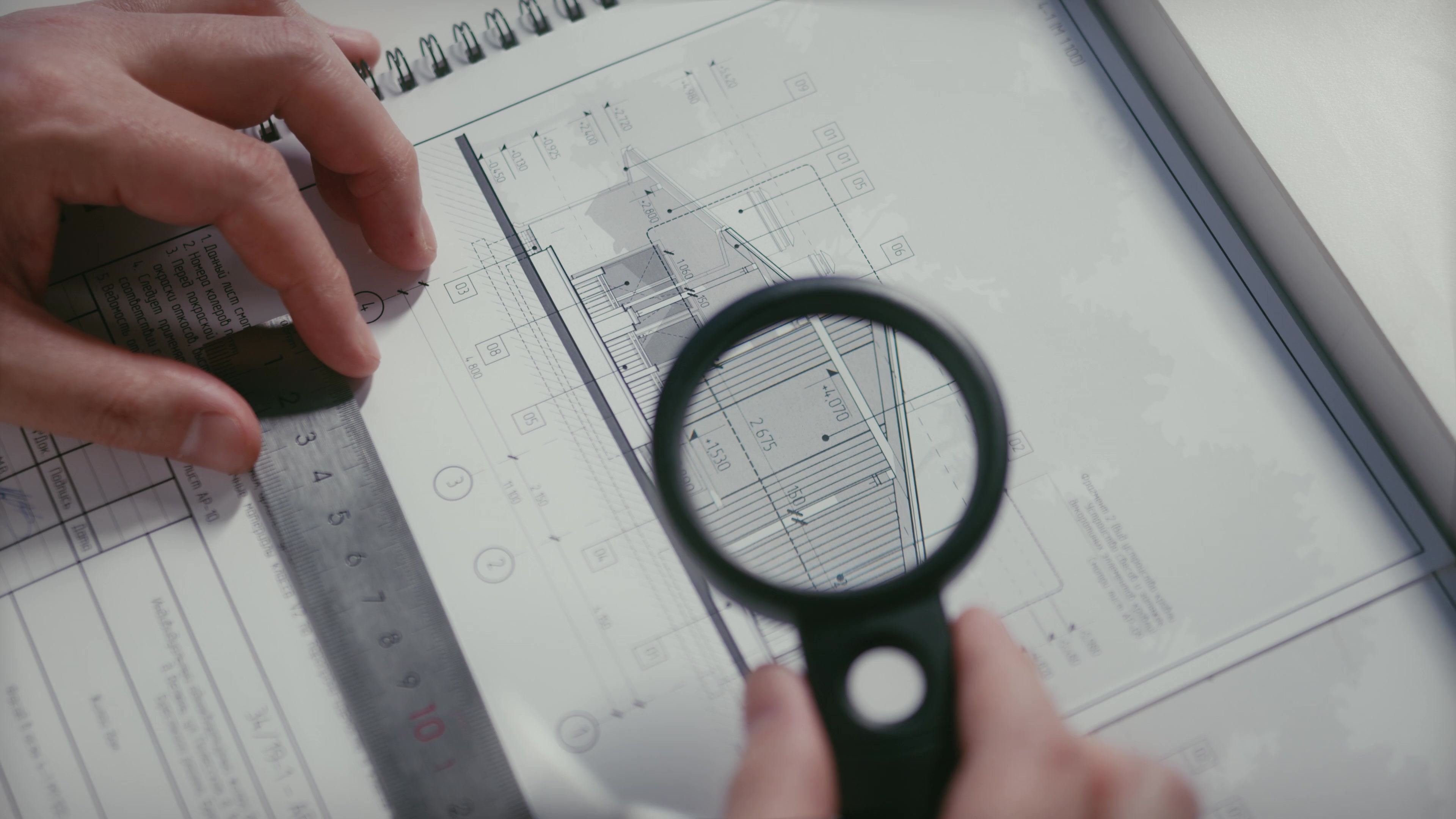 Architectural drawings examined through a magnifying glass