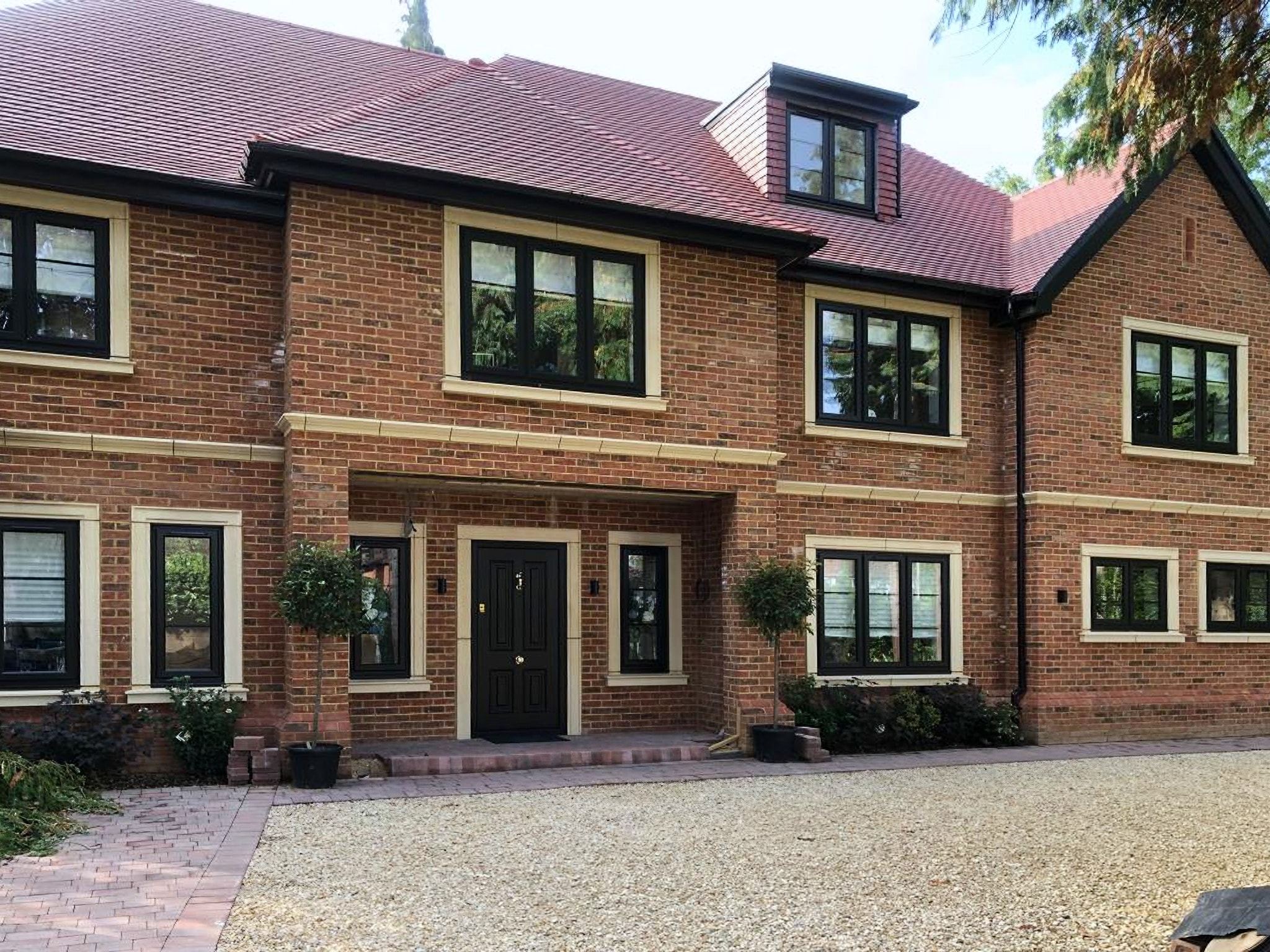 Detached brick house with dormer windows at Poyle Lane, Burnham