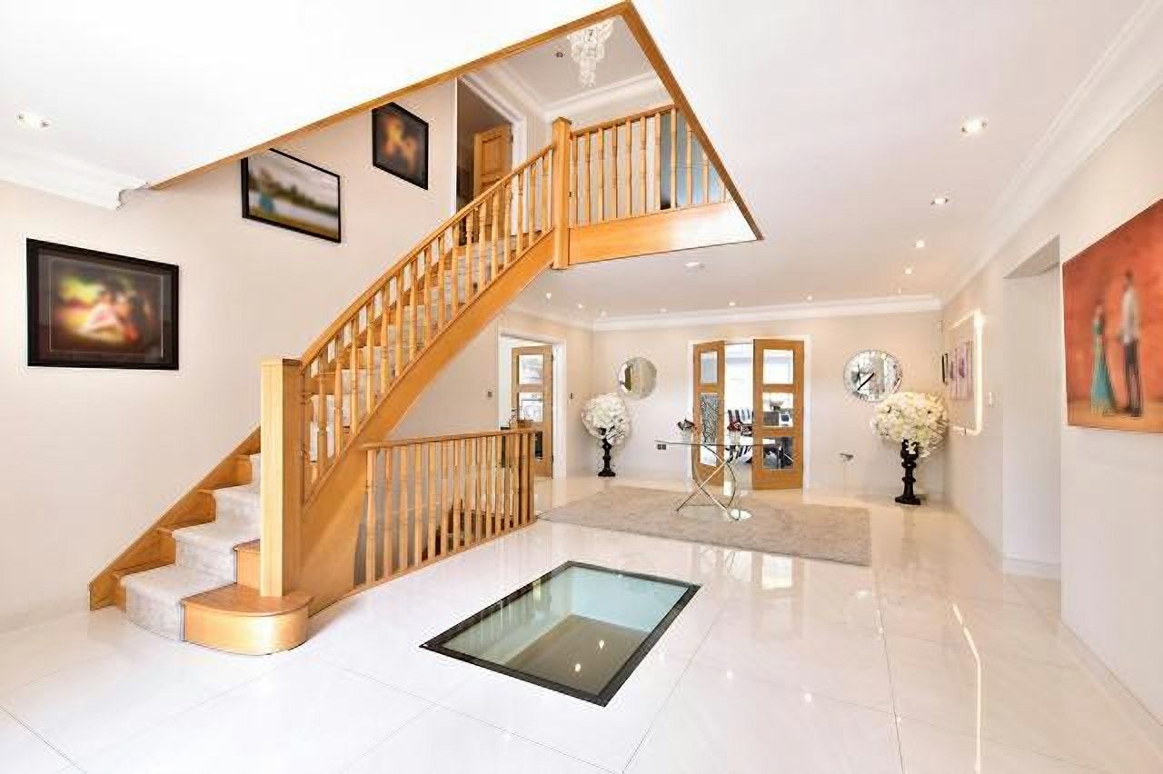 Oak staircase with a glass floor panel in the hallway